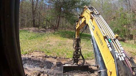 digging dich with skid steer|digging a drainage ditch youtube.